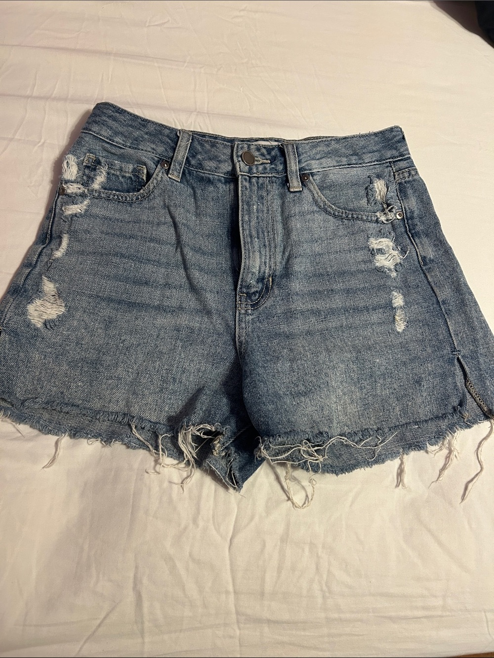 High-Rise Distressed Denim Shorts in Medium Blue